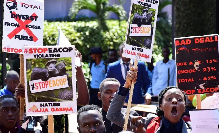Ugandan activists march in Kampala, Uganda, in support of a European Parliament resolution to stop the construction of the East African Crude Oil Pipeline on environmental grounds [File: Abubaker Lubowa/Reuters]
