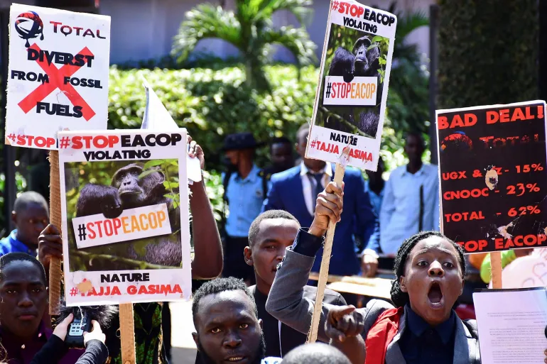 Ugandan activists march in Kampala, Uganda, in support of a European Parliament resolution to stop the construction of the East African Crude Oil Pipeline on environmental grounds [File: Abubaker Lubowa/Reuters]