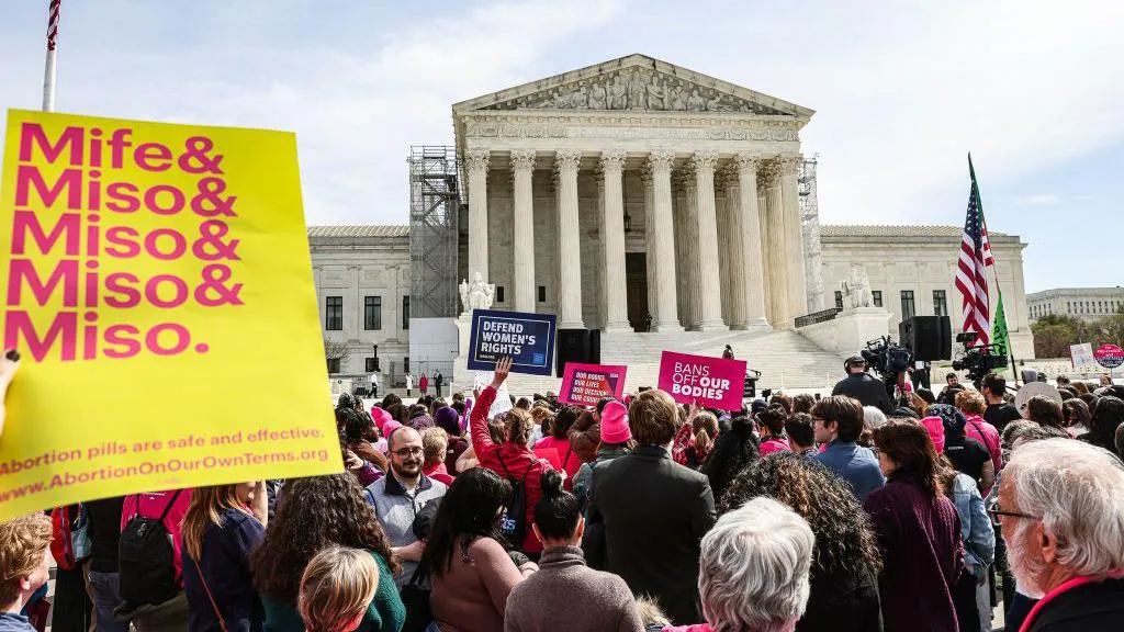 Demonstrators surrounded the Supreme Court in March as the justices heard arguments in the case