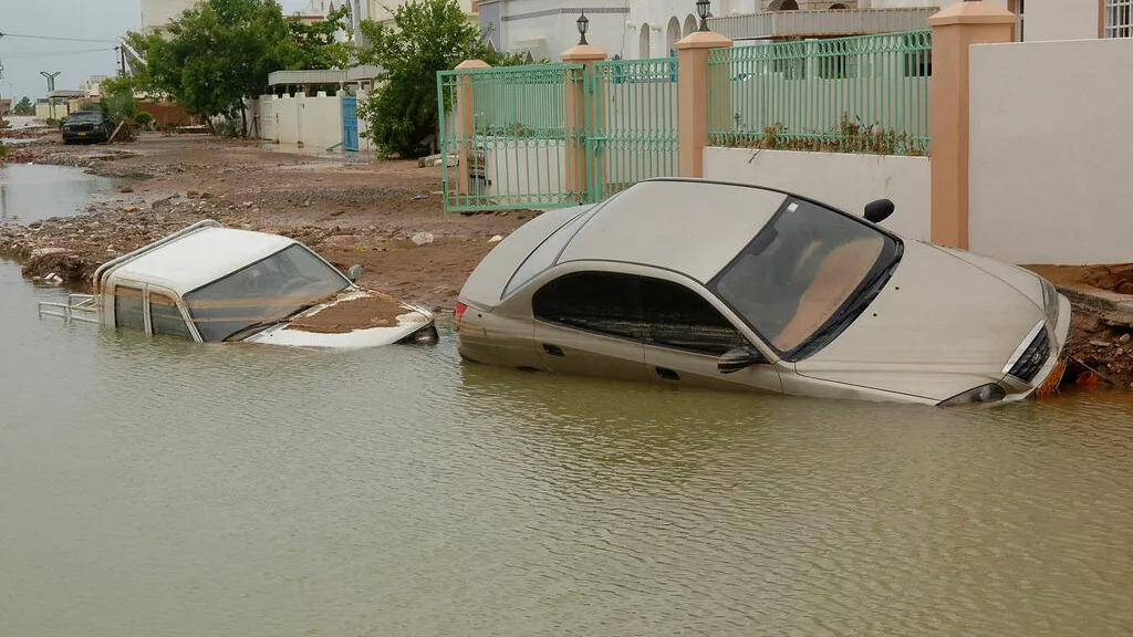 Vehicles are seen half submerged in flood water in Muscat, the Sultanate of Oman, Saturday, June 9, 2007