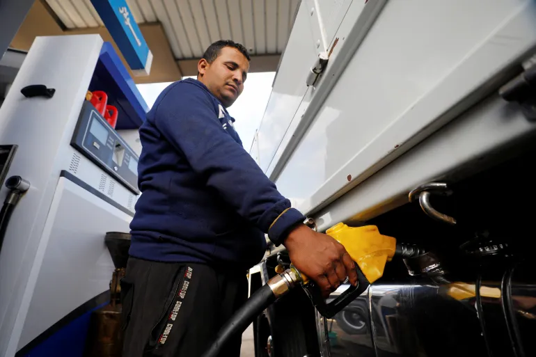 A worker fills a car's tank at a petrol station in Cairo, Egypt [File: Mohamed Abd El Ghany/Reuters]