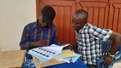 A man right checking his name in the voters register
