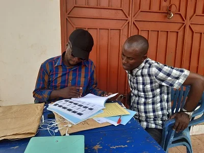 A man right checking his name in the voters register