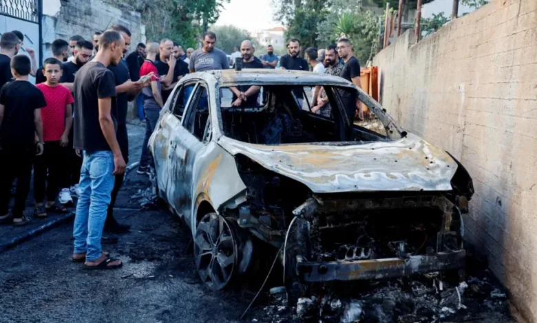 The destroyed vehicle that was carrying the three men