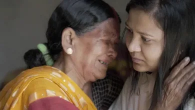 Midwife Siro weeps as she meets Monica, who was saved after being abandoned as a baby in the 1990s