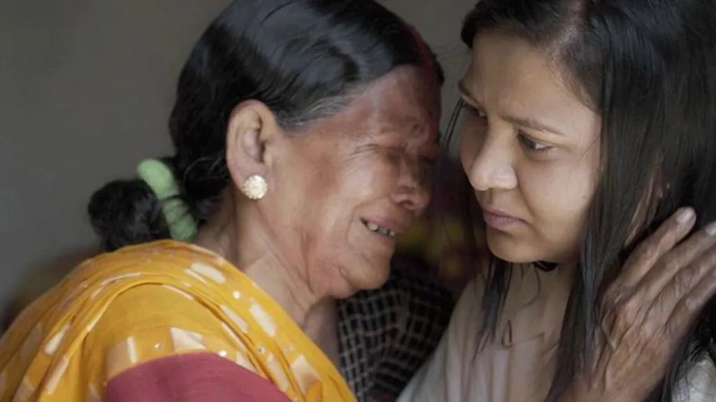 Midwife Siro weeps as she meets Monica, who was saved after being abandoned as a baby in the 1990s