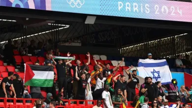 Fans hold the Palestinian and Israeli nationals flags