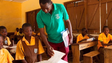 A teacher teaching his students in class.