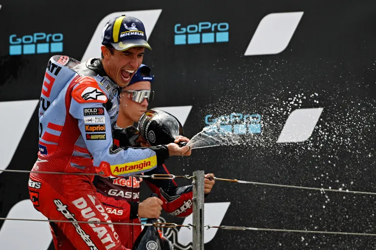 Marc Marquez celebrating on the podium after MOTOGP win