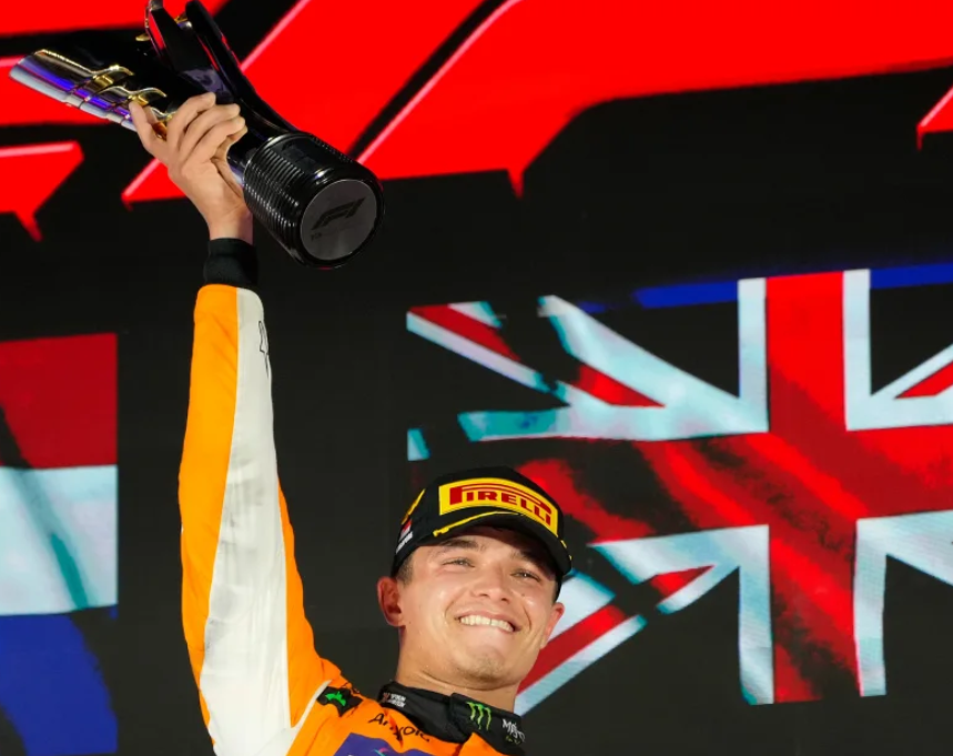 McLaren's Lando Norris celebrates on the podium after winning the Singapore Grand Prix