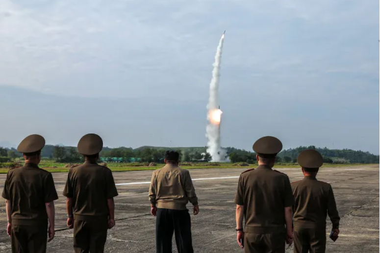 North Korean leader Kim Jong Un{middle} attends the launch