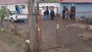 Police officials work at the scene of mass shooting in Lusikiki,South Africa
