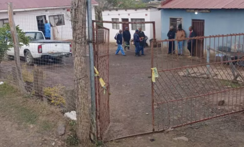 Police officials work at the scene of mass shooting in Lusikiki,South Africa