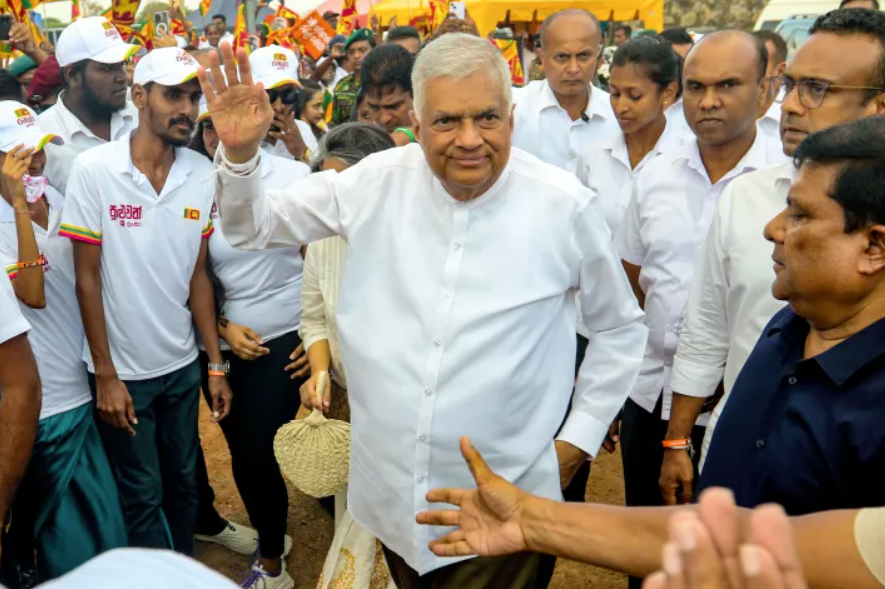 Sri Lanka's president and presidential candidate Ranil Wickremesinghe greets his supporters during an election rally