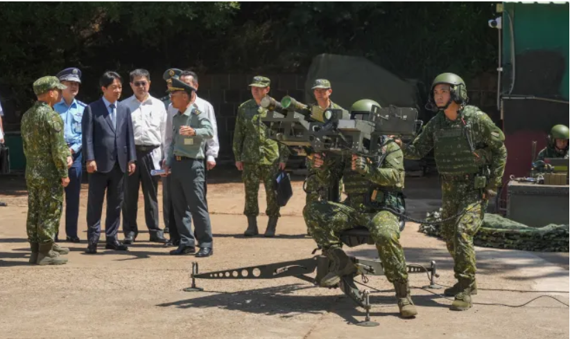 Taiwan president Lai Ching-te{4th left} watches a demonstration of US-made dual mount stinger air defence sysytem