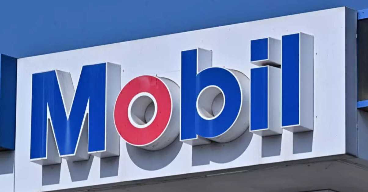 The mobil sign is seen at an exxonmobil gas station