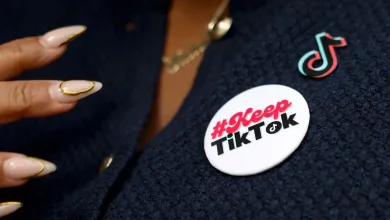 A TikTok creator wears a badge in support of the platform