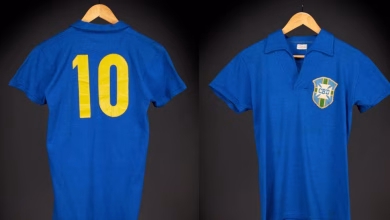Two blue football shirts hang against a dark background, showing a yellow number 10 on the back and a Brazil-style CBD crest on the front.