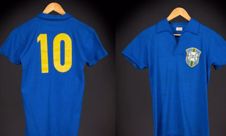 Two blue football shirts hang against a dark background, showing a yellow number 10 on the back and a Brazil-style CBD crest on the front.
