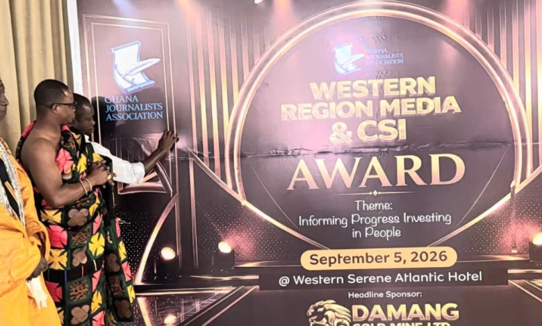 Several people stand beside a large event display for the Ghana Journalists Association Western Region Media and CSI Award.